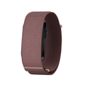 A rose gold fabric smartwatch band with a textured woven pattern and a small gold metal snap closure, shown on a white background.